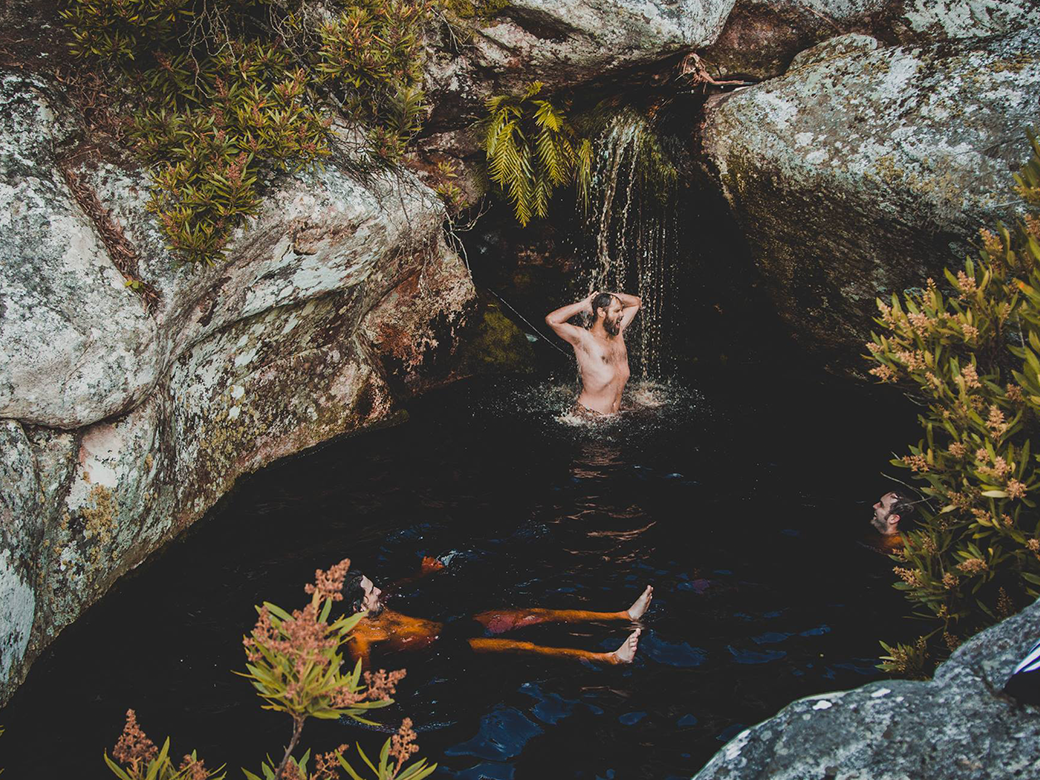 men swimming in nature