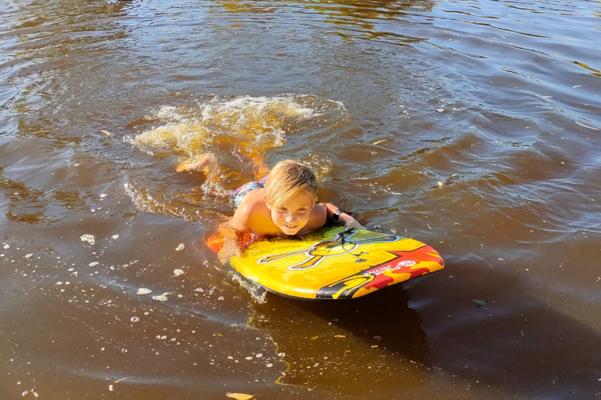 Boy swimming in river